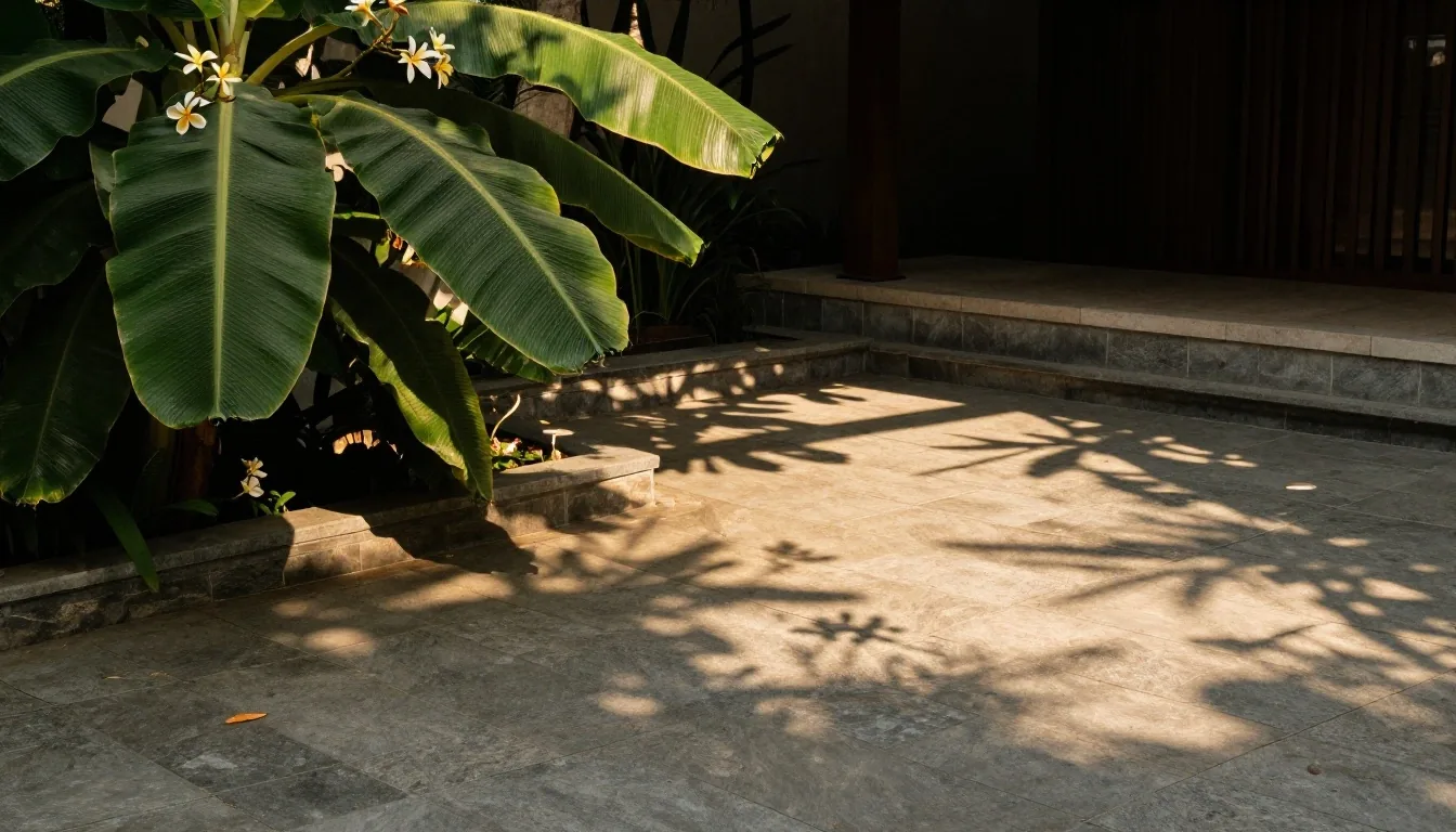 Courtyard of the PrimaVita compound with tropical plants and slate tile paving